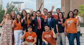 Group of students posing in front of the UT Tower